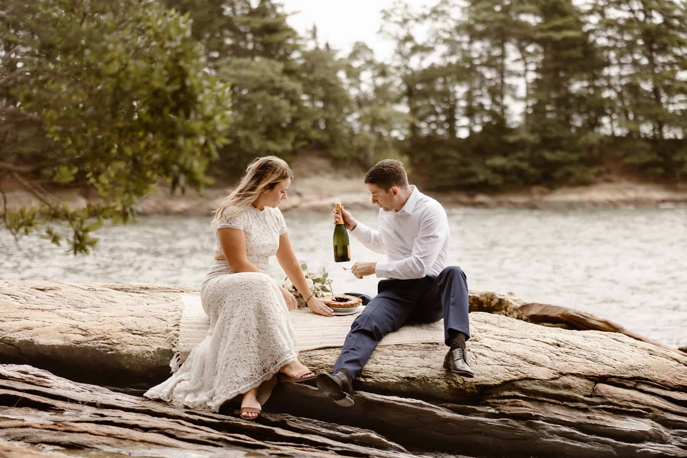 A couple celebrating eloping in Freeport with a champagne bottle and a pie.