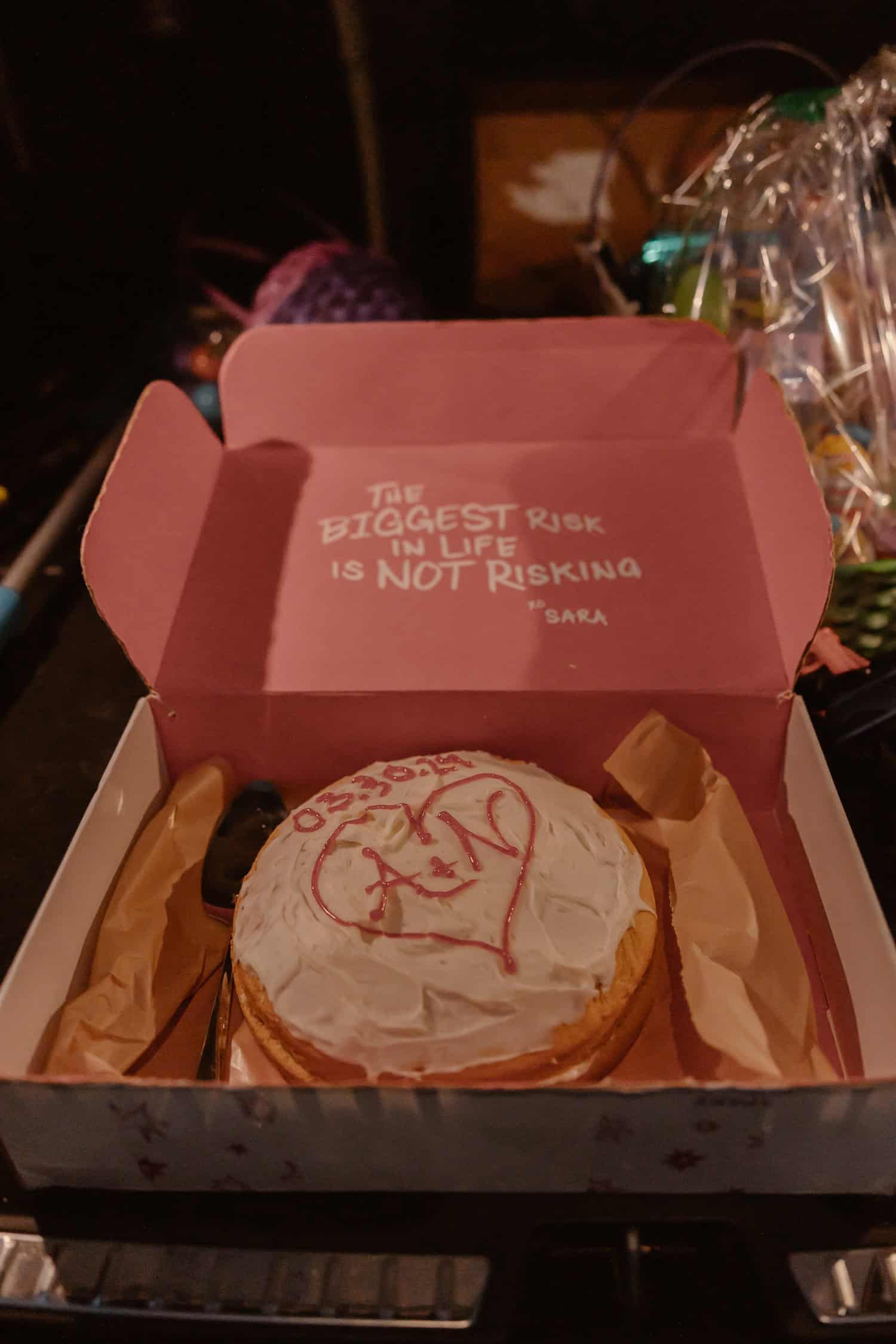 A wedding cake in a box. The box says "The biggest risk in life is not risking." A fitting message for this rappel elopement!