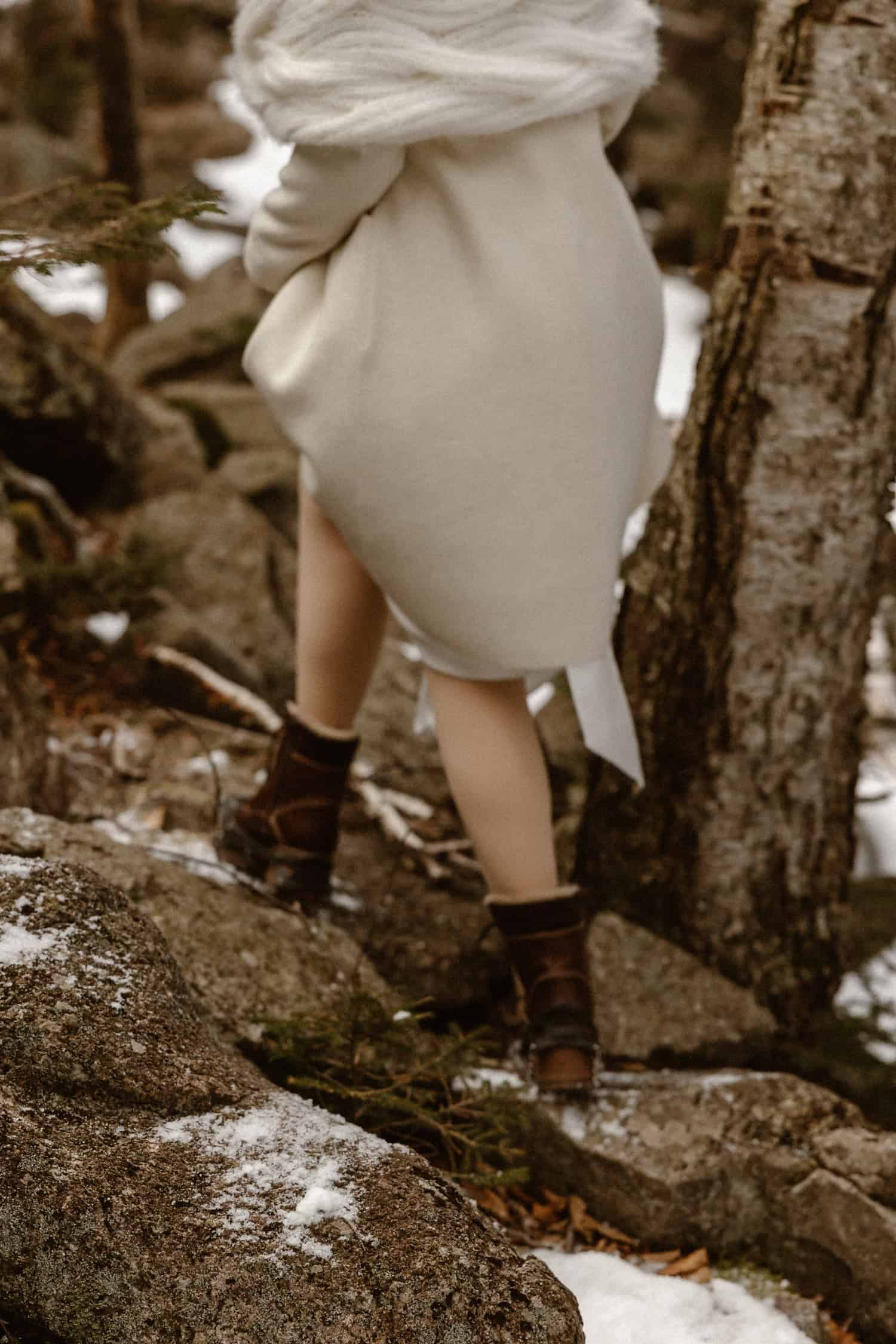 A closeup of a bride's hiking boots, as she climbs up to Artist's Bluff for her rappel elopement.