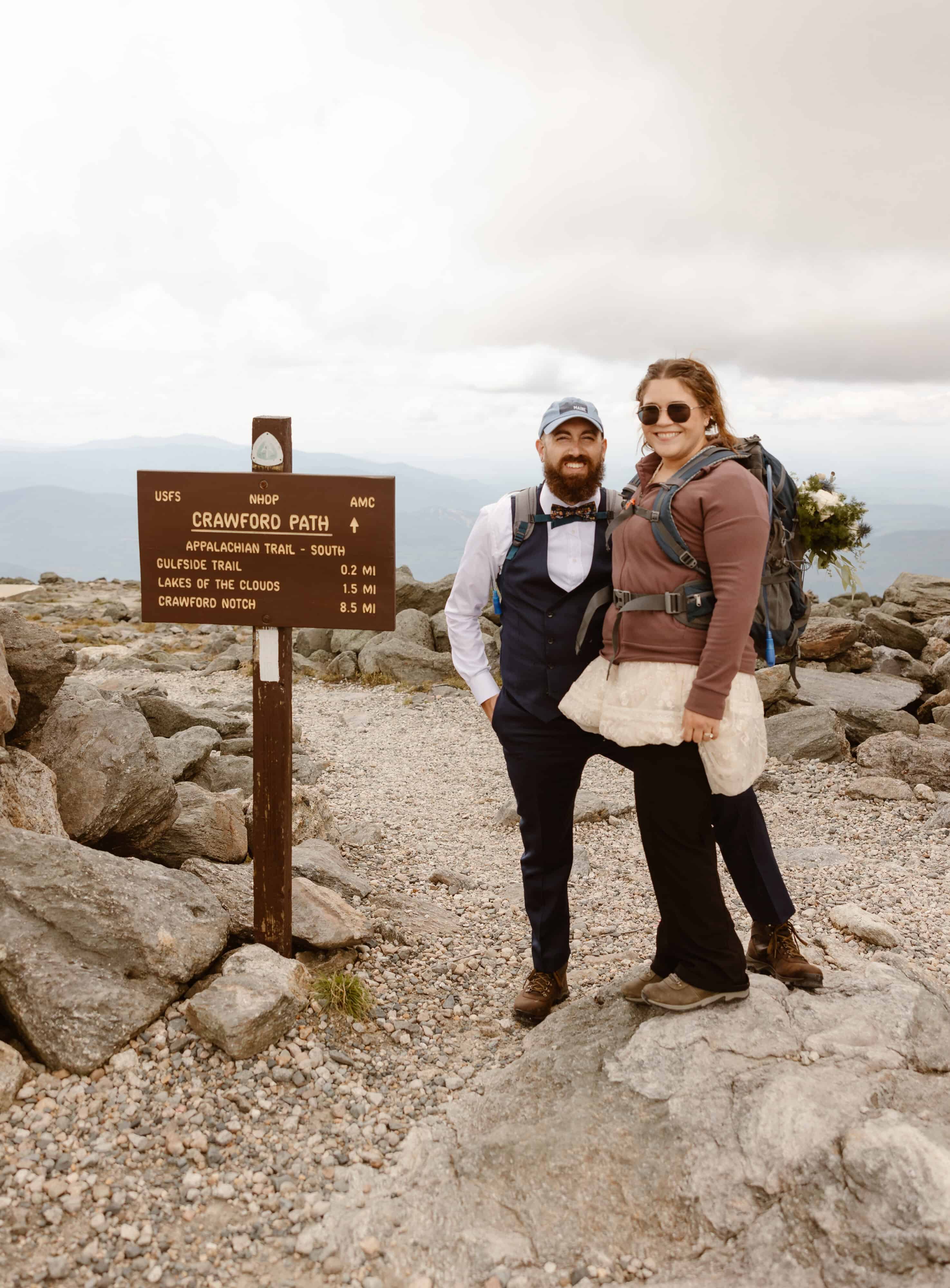 A couple hikes along Mount Washington for their elopement