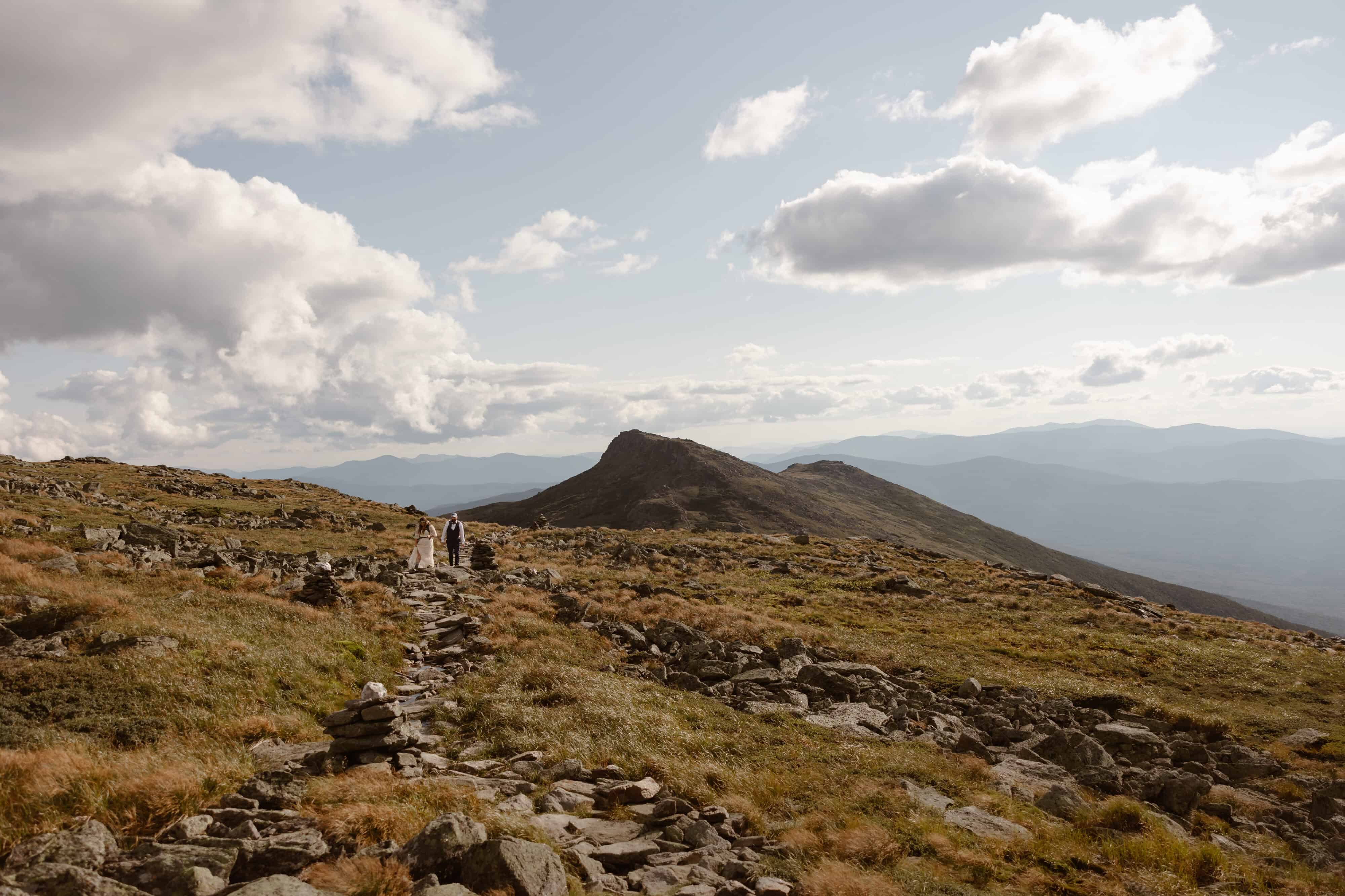 A couple hiking from Lakes of the Clouds back to the Mount Washington summit during their elopement