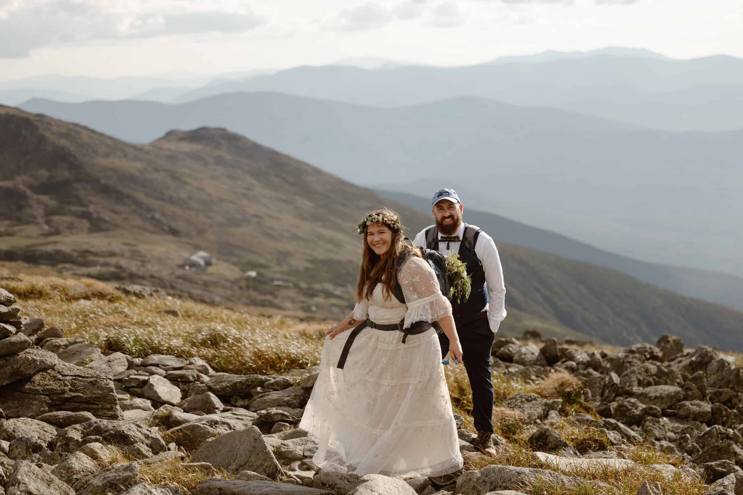 a couple hiking to the summit of Mount Washington on their elopement day.