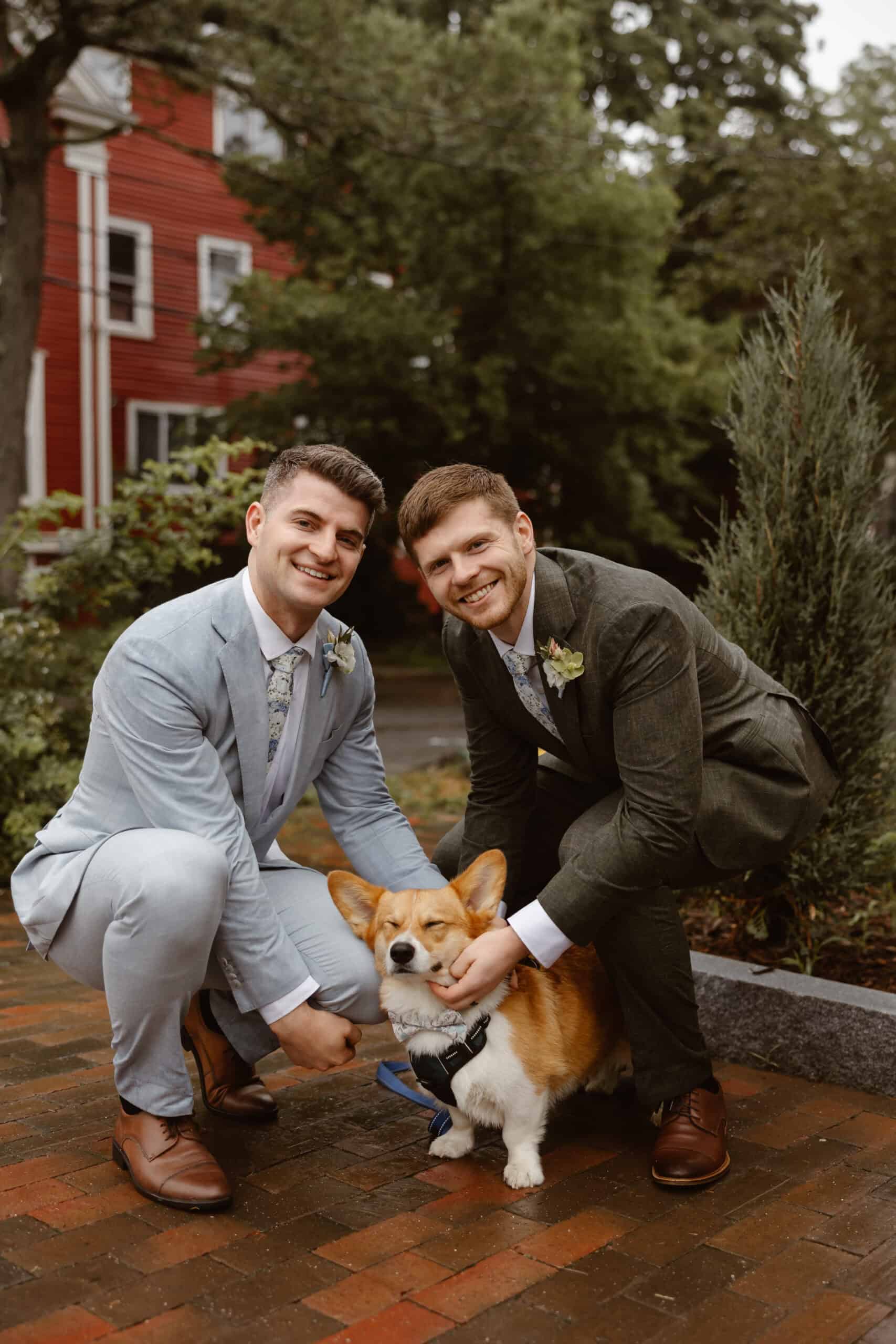 A couple smiles with their dog on their elopement day in Portland, Maine